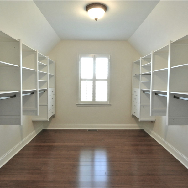custom walk in closet with angled ceiling