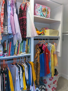 custom kids closet with hanging clothes