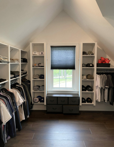 Angled ceiling shelving and hanging storage with mens shirts and hats