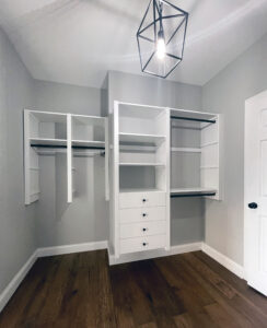 walking closet with white hanging shelves