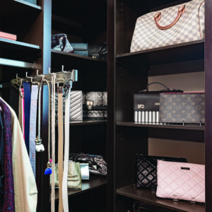 Corner closet shelving with womens' handbags displayed