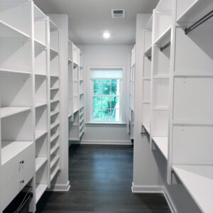 White walk in closet with shelving and hanging sections