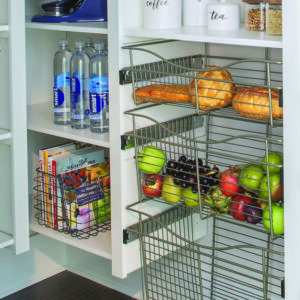 Section of pantry with glide-out wire baskets containing fruit