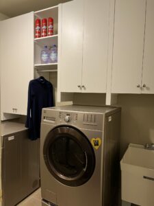 Image of laundry room shelving with doors and a hanging rod for hanging clothes
