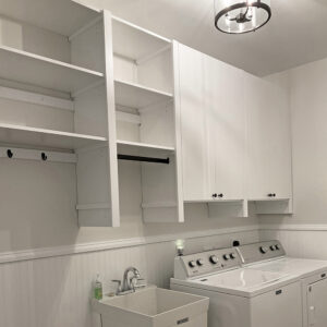Laundry room shelving with doors over washer and dryer