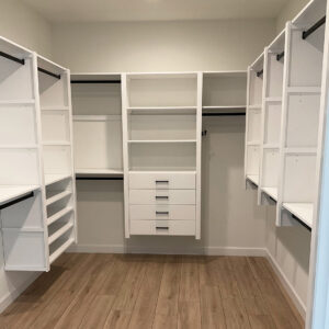 White closet with black hardware and 4 center drawers