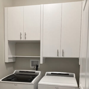 Laundry room washer dryer with storage cabinets above